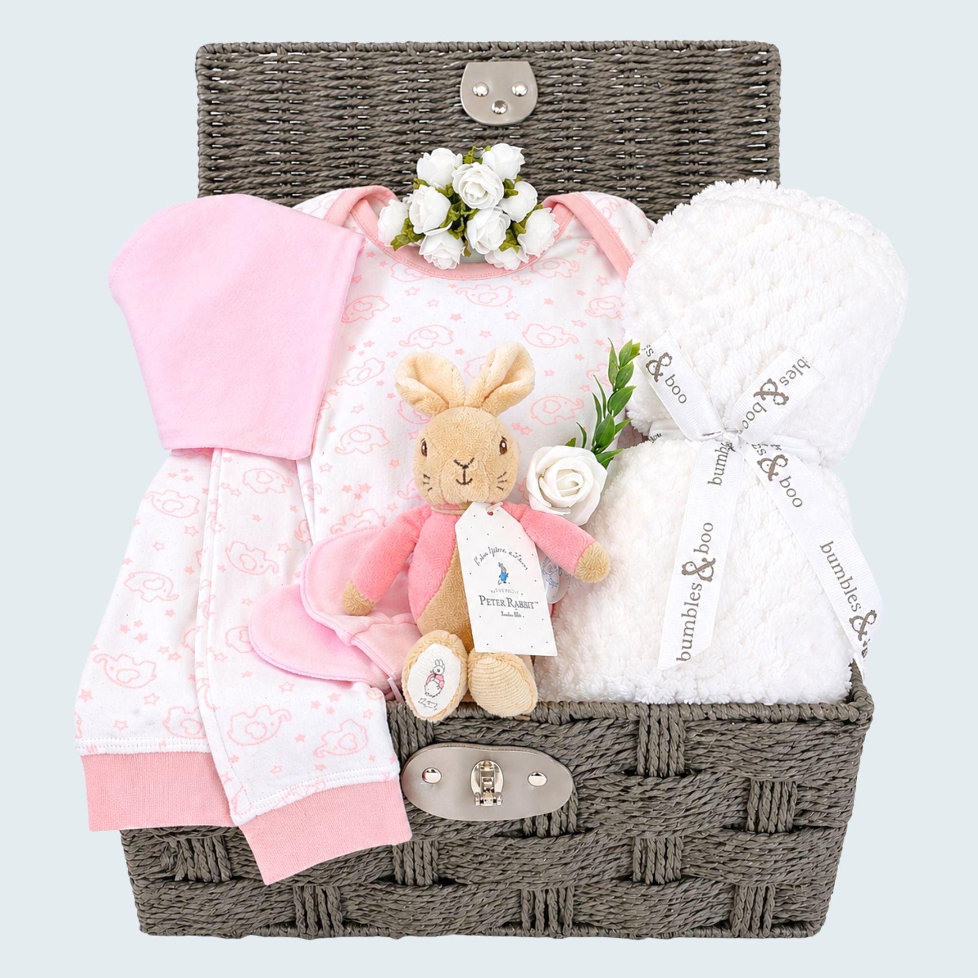 Baby girl hamper basket with gifts of pink pyjamas, white baby blanket, and bunny soft toy. Bumbles and Boo.