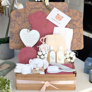 Baby girl hamper box with gifts including dusky pink clothing, and essential newborn presents in a eco friendly gift box by Bumbles and Boo.
