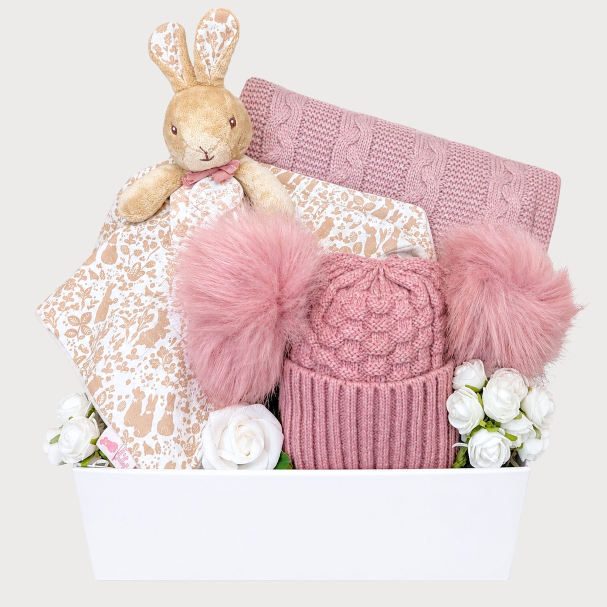 Baby girl gift box by Bumbles and Boo. Gifts in this hamper include dark pink Pom Pom hat and flopsy bunny comforter.