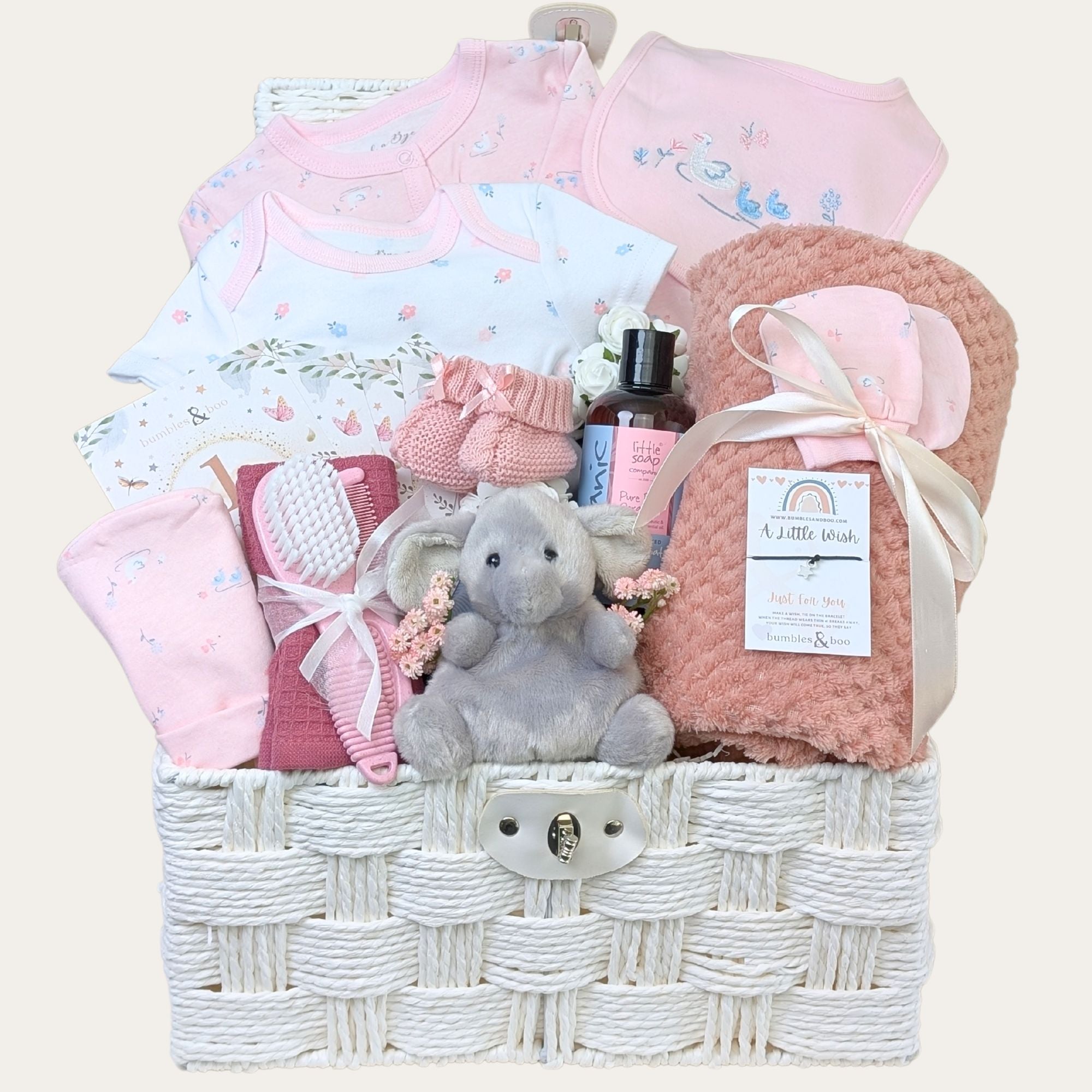 Dusky pink baby girl gifts basket with clothing and elephant soft toy in a hamper by Bumbles and Boo.
