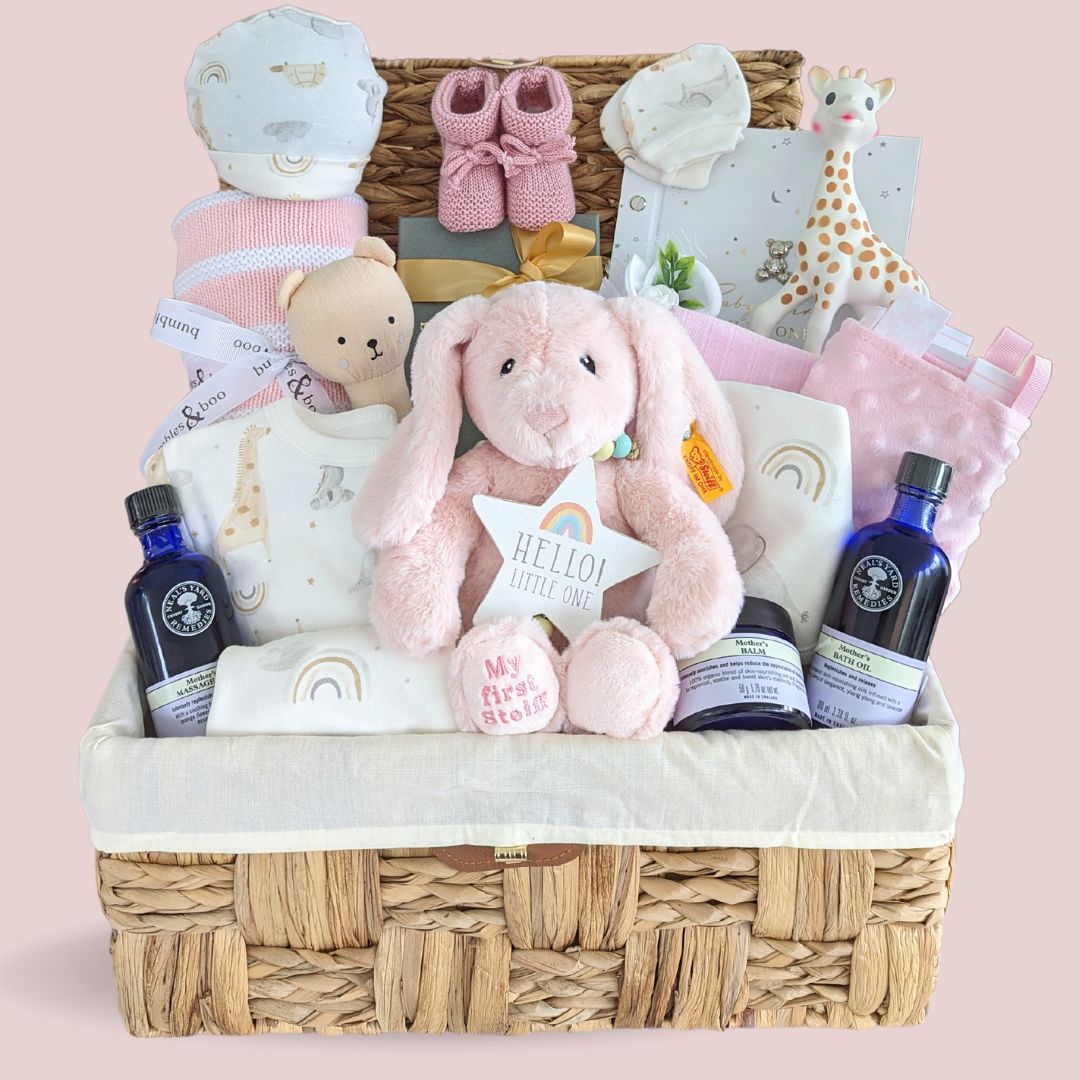 Baby girl gifts hamper packed with pink and white presents for mum and baby.