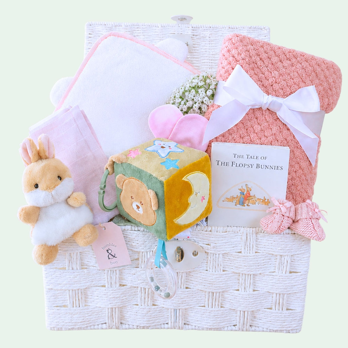 Baby girl hamper gift with pink congratulations gifts in a bear and bunny theme in a white gift basket.