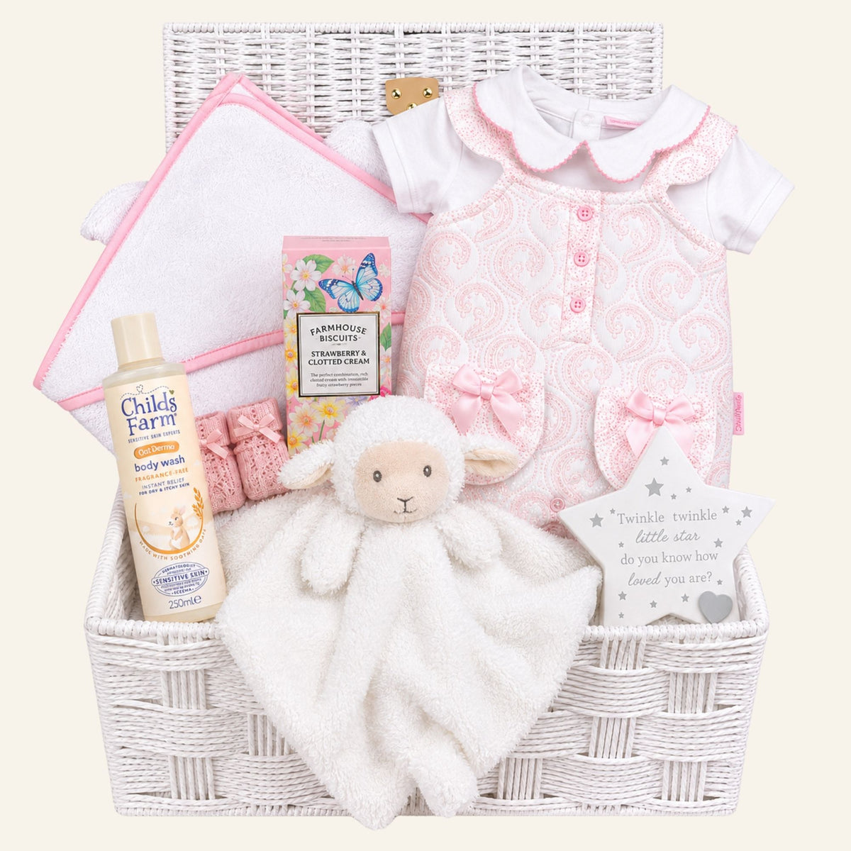 Baby girl hamper basket with pink romper and personalised hooded towel. Little lamb comforter in white.