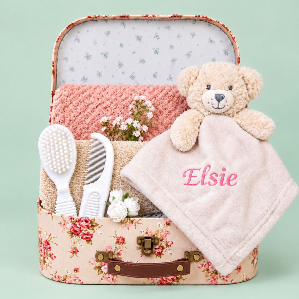 Personalised baby girl hamper gifts in a vintage rose trunk with Elsie embroidered in pink on the comforter