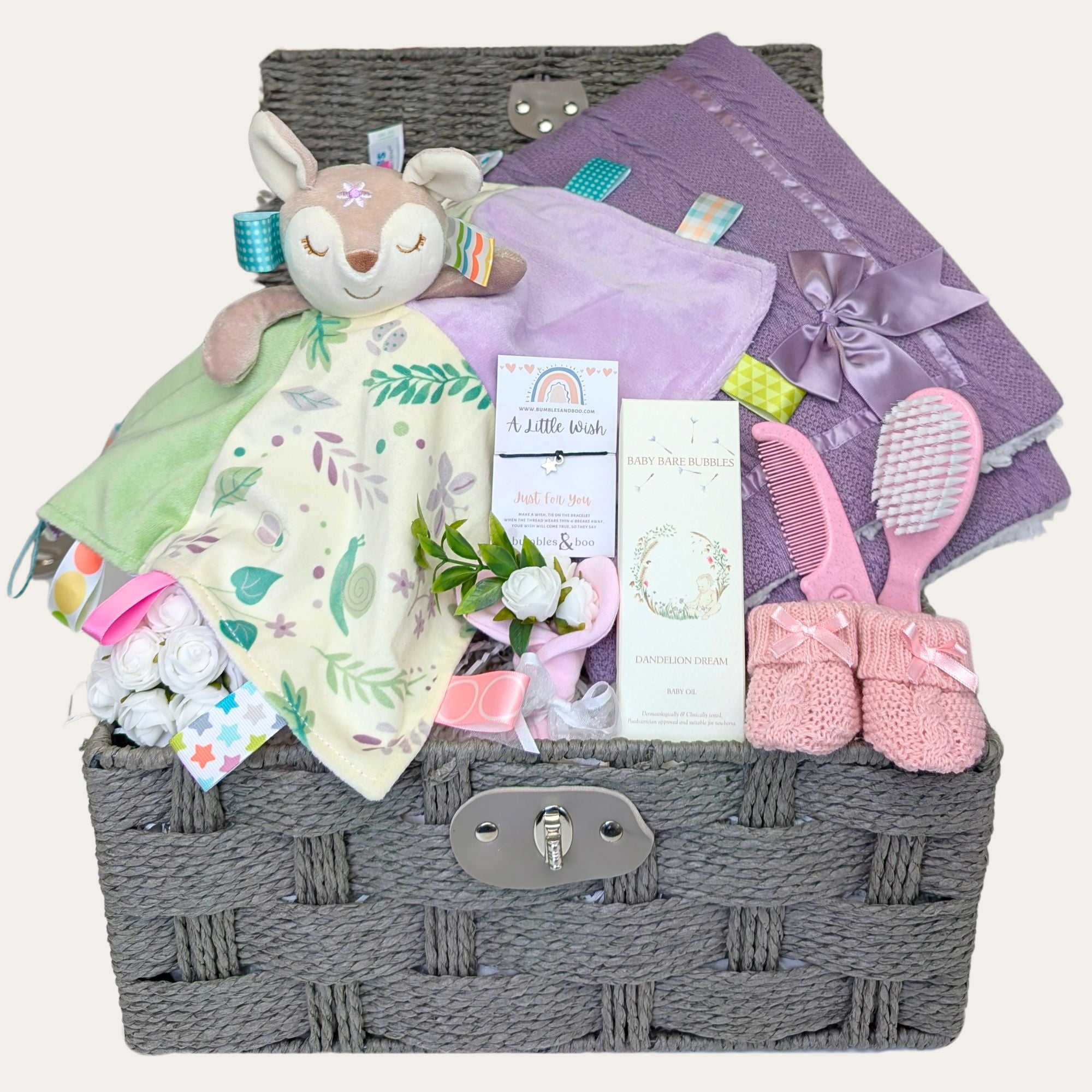 Luxury new baby girl hamper basket with gifts including Flora Fawn taggie comforter by Bumbles and Boo.