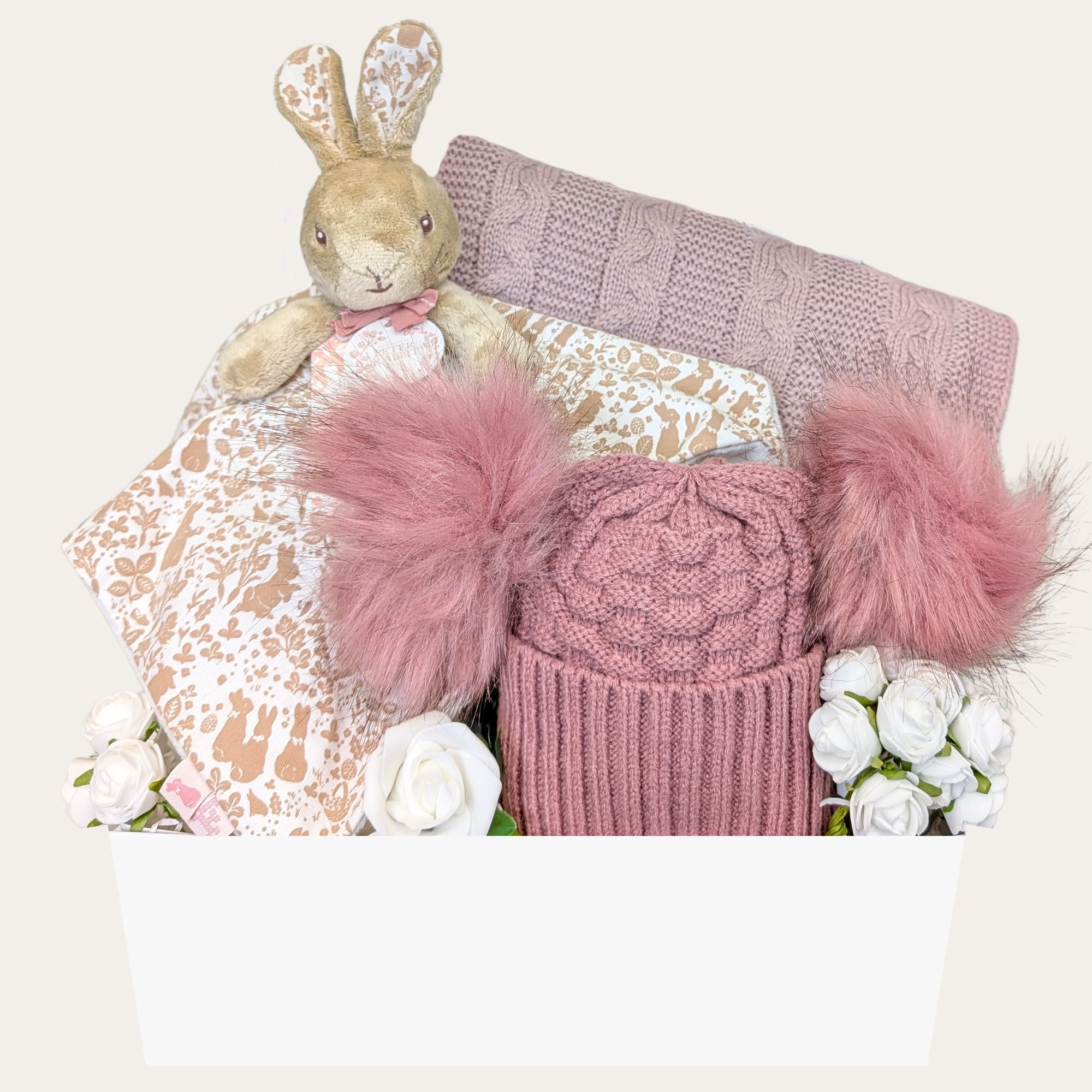 Baby girl gift box by Bumbles and Boo. Gifts in this hamper include dark pink Pom Pom hat and flopsy bunny comforter.
