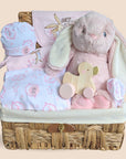 Baby girl hamper with stunning bunny clothing set, cuddly bunny soft toy and wooden baby toy. Award winning baby hampers perfect baby gifts for a new baby / baby shower.