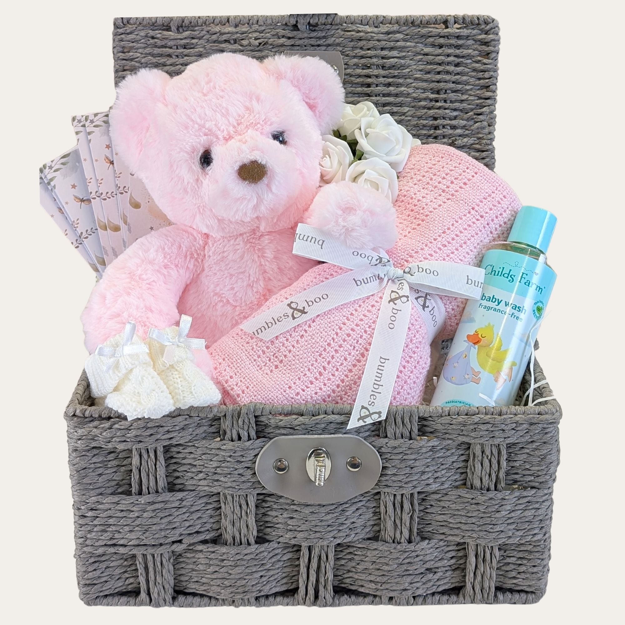 Newborn baby girl gifts hamper with pink teddy, blanket packed in a basket by Bumbles and Boo.