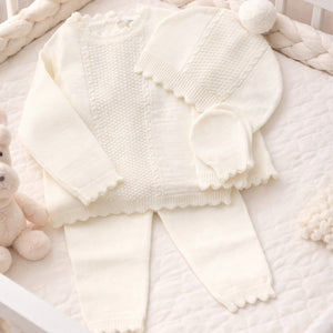 Cream knit baby girl clothing set with scalloped edges