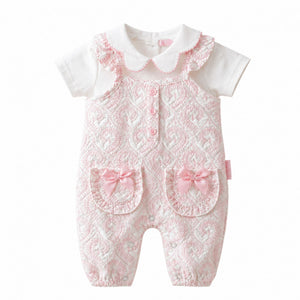 Set of baby rompers and a shirt with floral pattern on a baby