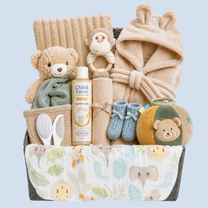 Baby hamper for boys which includes beige dressing gown, teddy comforter and sensory toys.