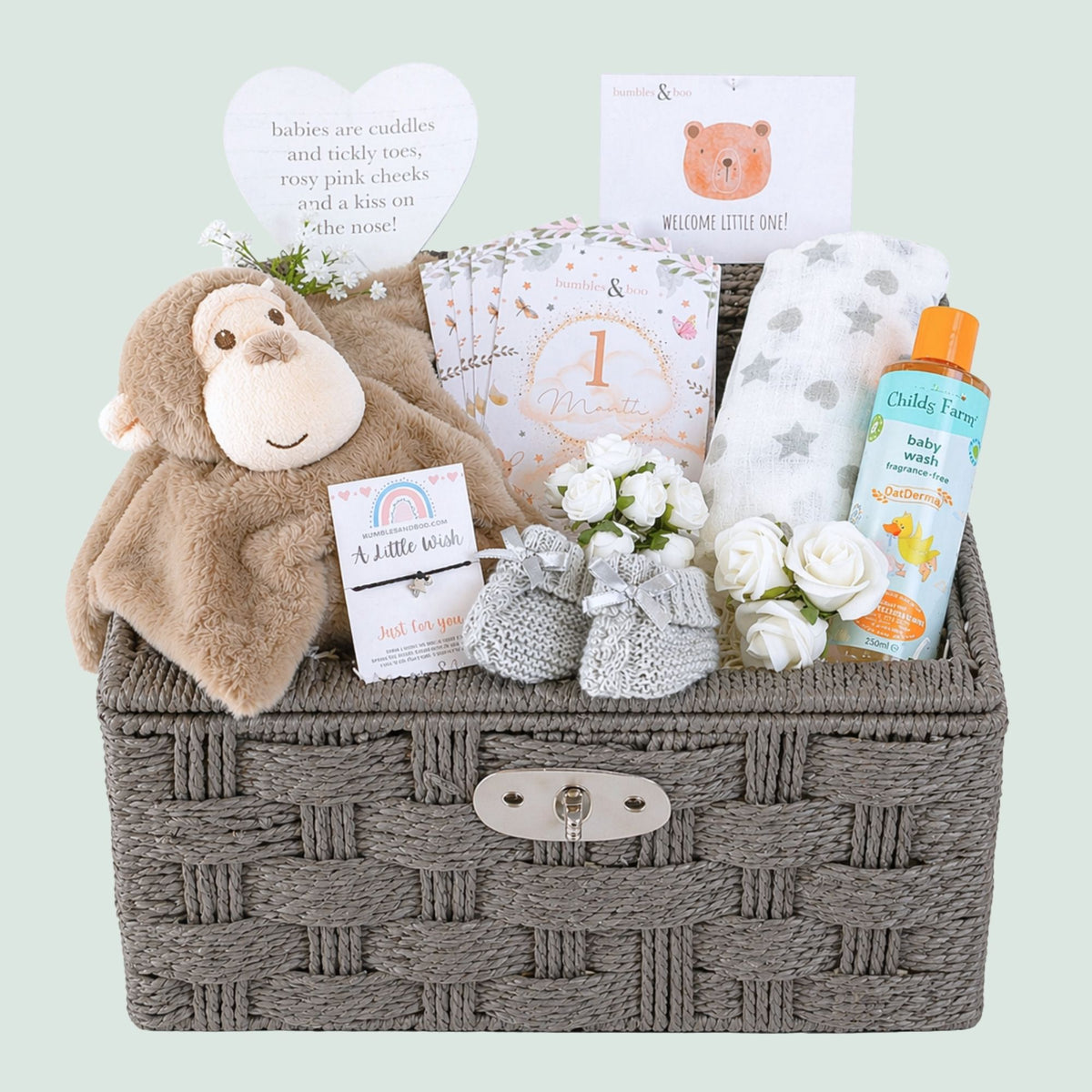 Baby hamper gifts basket with monkey comforter and organic baby wash in a brown wicker basket