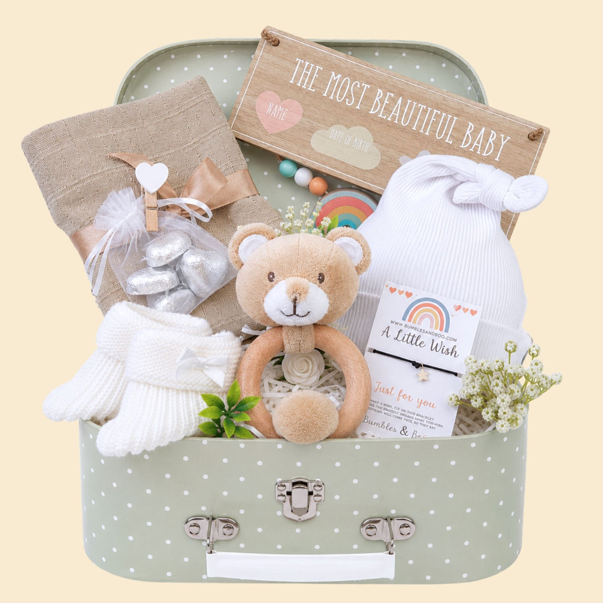 Baby hamper gifts which include a teddy rattle and newborn accessories with some chocolates
