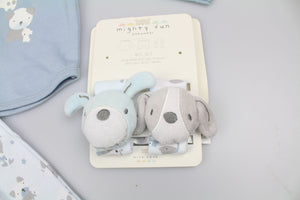 Close-up of blue and grey puppy wrist rattles with embroidered faces, attached to their display card.