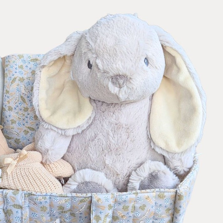 Baby Shower Gifts in a Nappy basket.  With a large cream rabbit plushy and leaf design caddy.