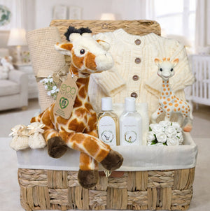 A present for a baby shower hamper with a cream knitted cardigan and giraffe soft toy.