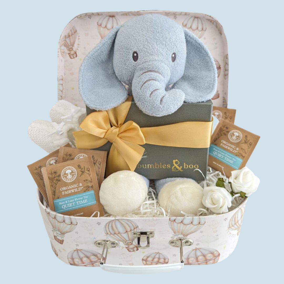 baby shower hamper with delicious chocolates for mum to be, plus organic tea bags, baby knit booties and elephant soft toy for baby. Presented in a keepsake luggage trunk hamper.