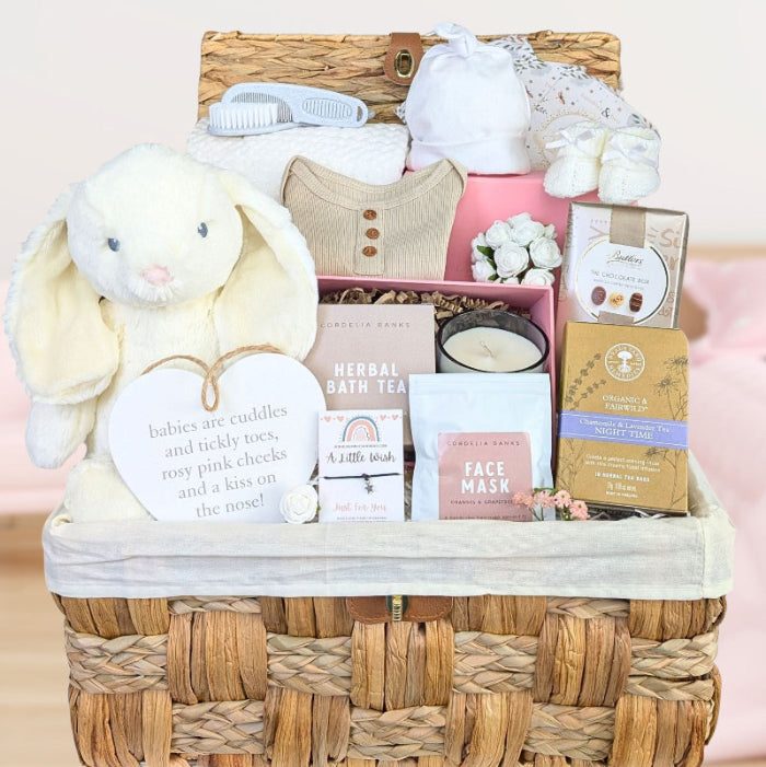 Baby shower hamper basket with lots of gifts for mum and baby in neutral unisex colours