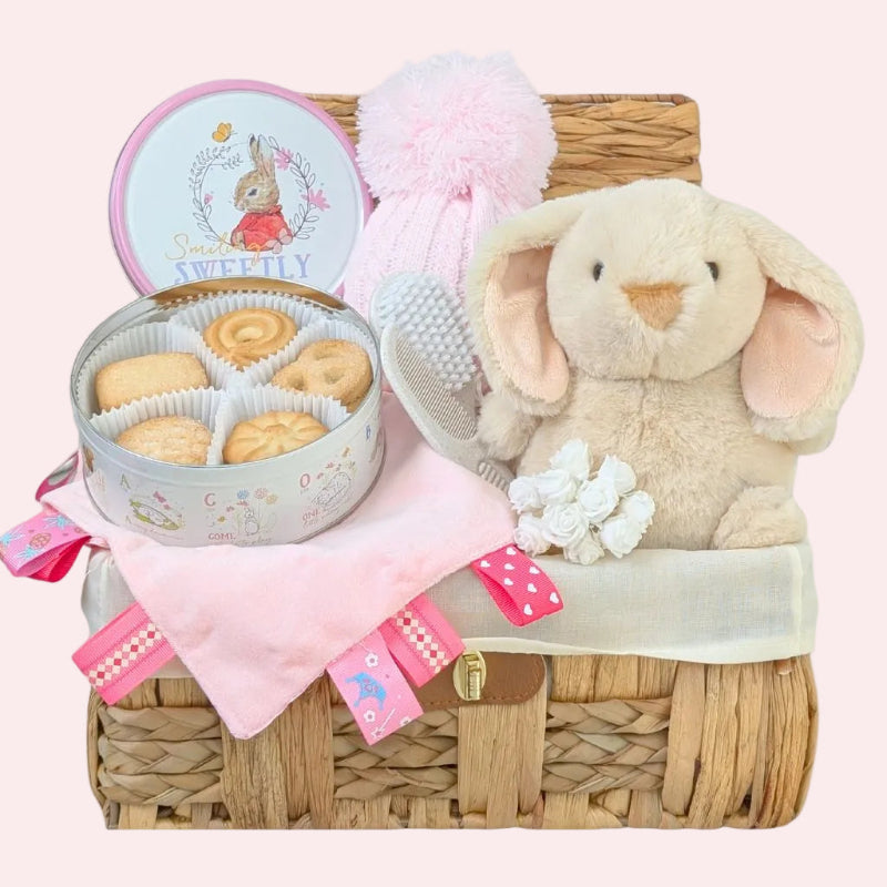 Pink and cream baby shower hamper basket with gifts including delicious treats for mum and presents for her new daughter by Bumbles and Boo