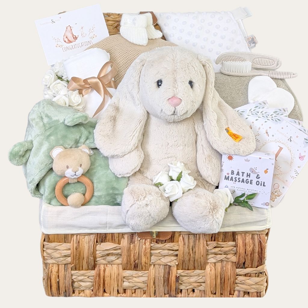 Luxury baby shower gifts hamper with oversized cream Steiff bunny, sage green baby essentials, and thoughtful presents for new parents and baby.