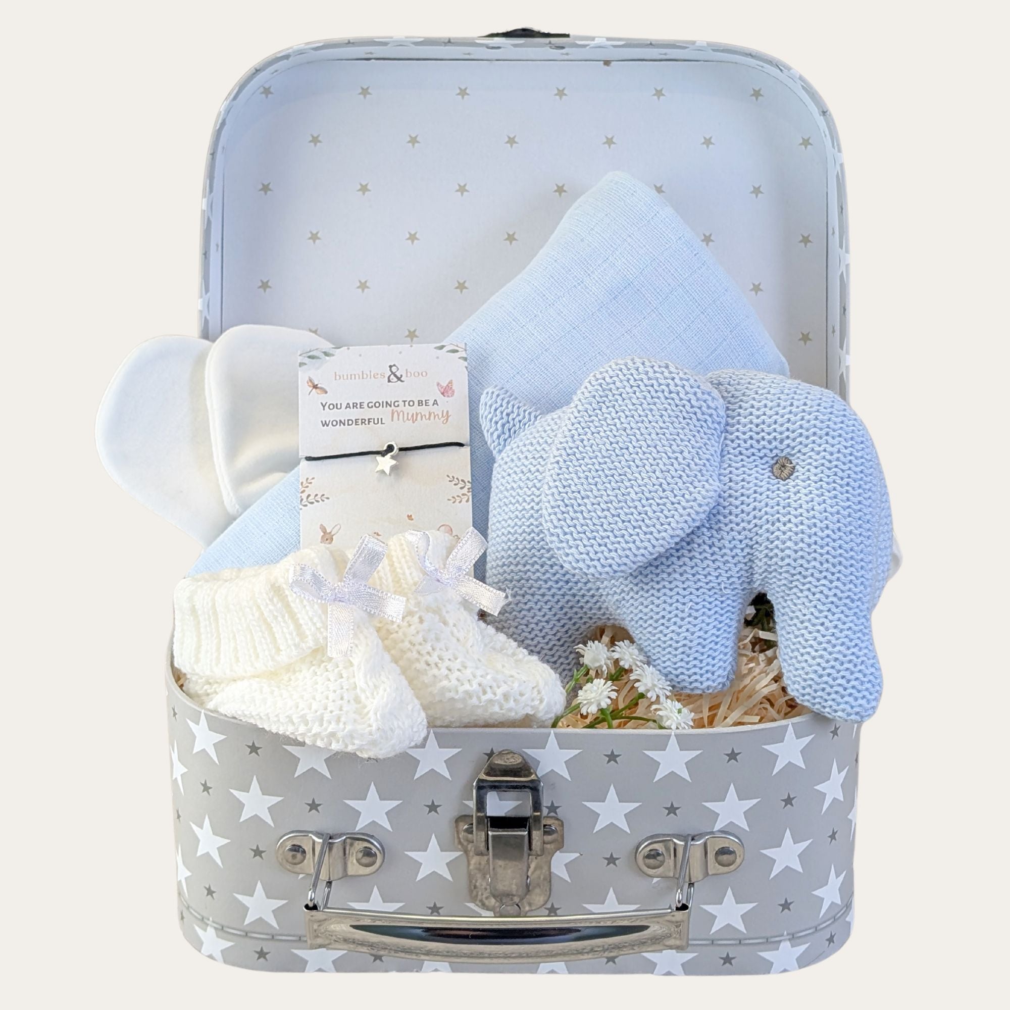 Baby shower gifts for boy with presents including pale blue elephant rattle in a stars hamper.