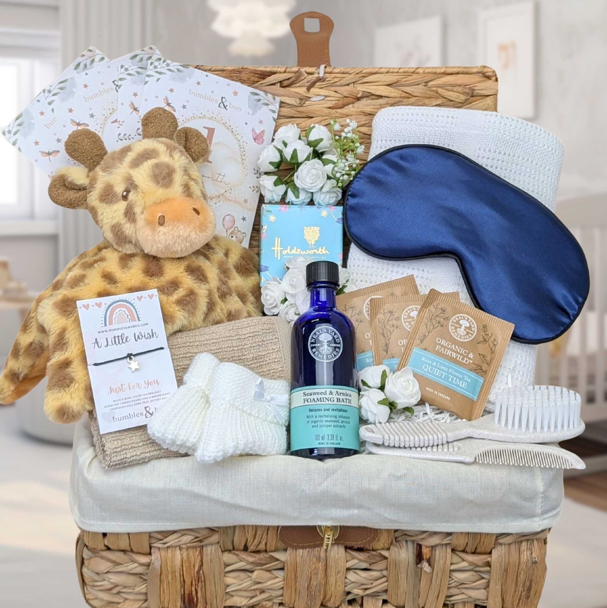 Giraffe themed baby shower basket with presents including chocolate.