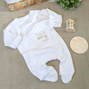 New Baby sleepsuit which reads 2026 new arrival in white with poppers.