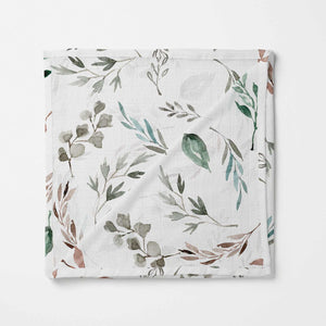 Extra-large bamboo swaddle blanket with a whimsical soft green botanical print. This dreamy swaddle brings a touch of serene greenery, keeping baby snug and stylish. made from organic cotton and bamboo.