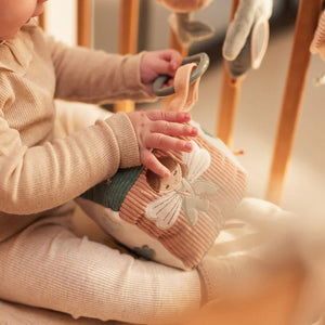 Textured baby activity cube with birds and flowers