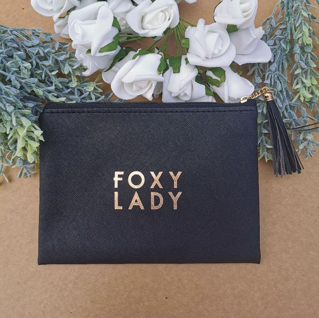 Black coin purse with the words &#39;foxy lady&#39; printed in the centre.