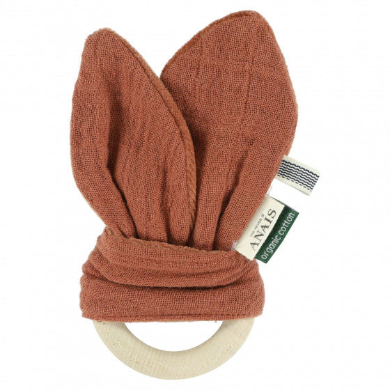 Wooden ring teether with rust-orange fabric in a bunny ears shape.