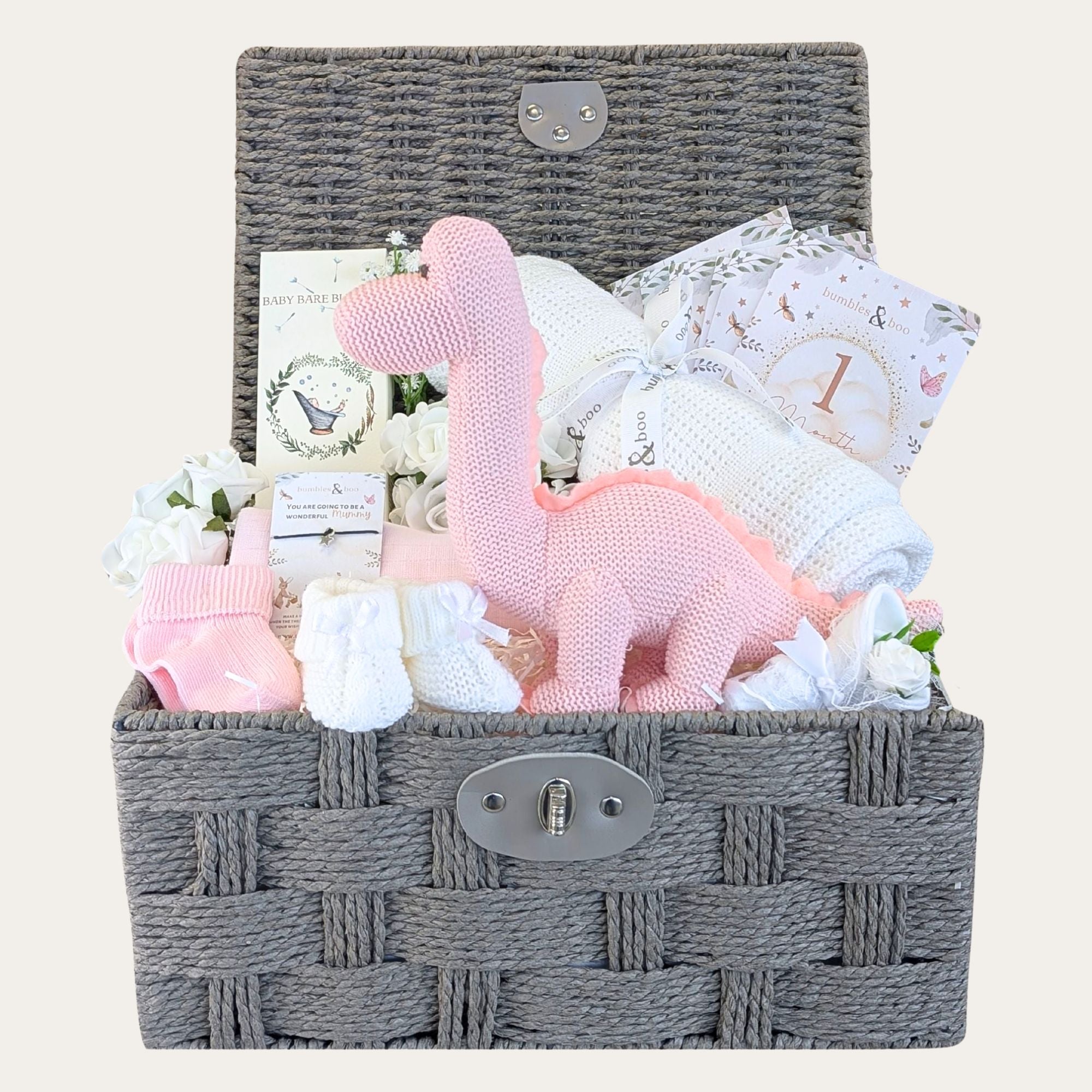 Baby girl gifts basket with presents including pink dinosaur and cellular baby blanket in a dark brown hamper by Bumbles and Boo.