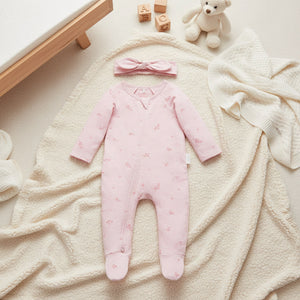 Pale pink Blossom baby girl clothing zip growsuit with matching knot headband in organic cotton. Soft baby clothes with full length zip and feet.