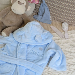 Blue baby bath robe with blue embroidery.