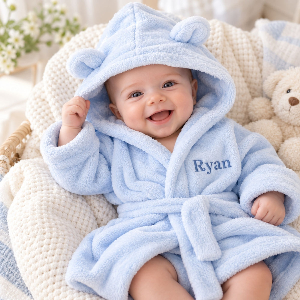 Blue personalised baby dressing gown with ears on the hood, embroidered with the name 'Ryan' to make a personalised baby gift