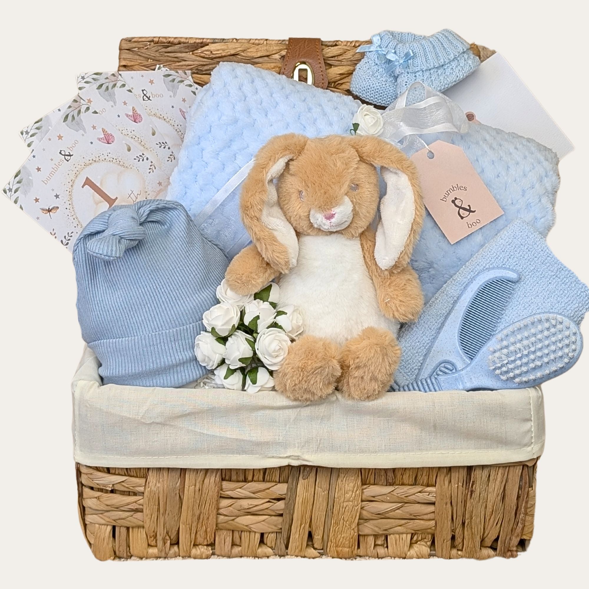 Adorable baby boy gifts basket with bunny. Presents in this hamper are baby blue. Bumbles and Boo.