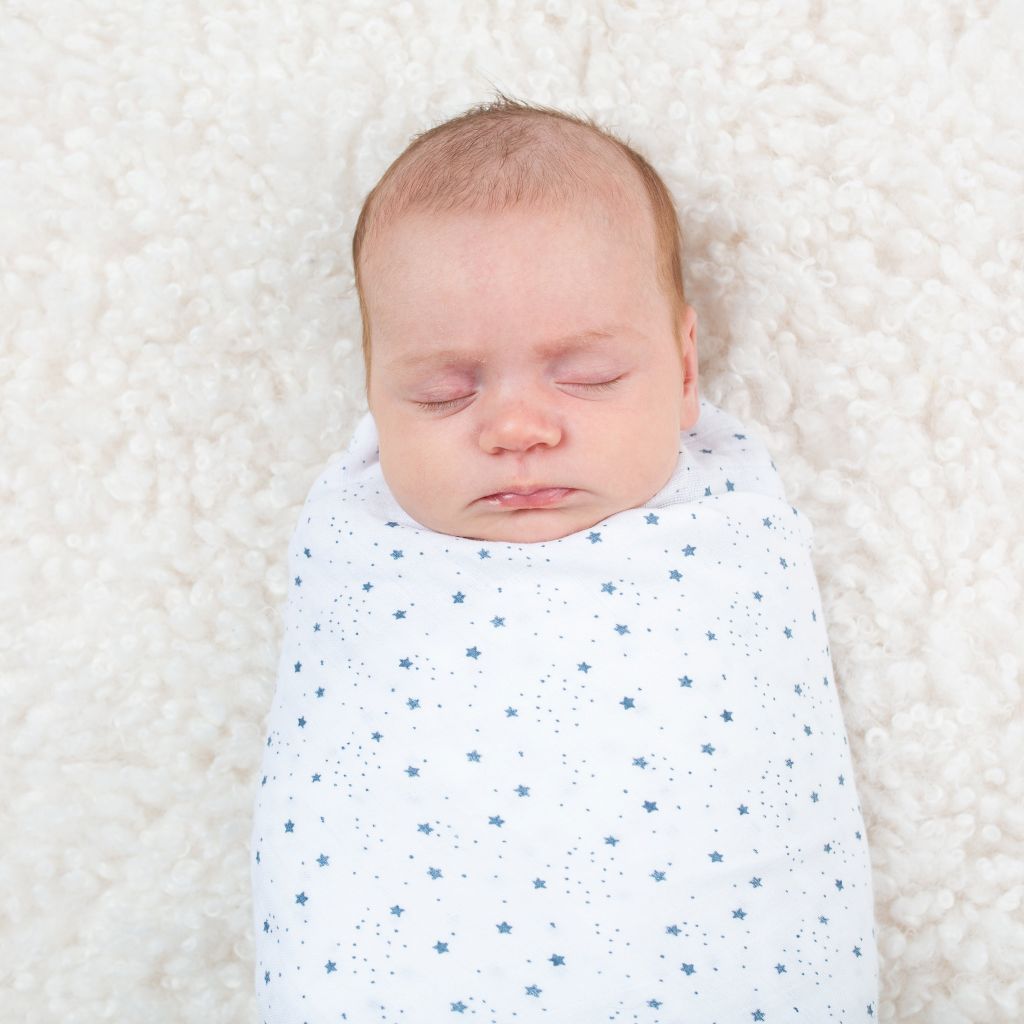 White baby swaddle with blue stars.