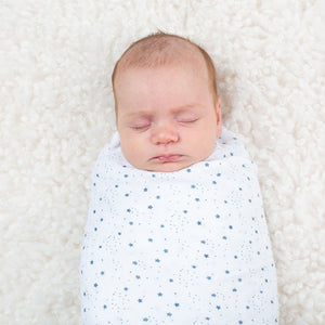 White baby swaddle with blue stars.
