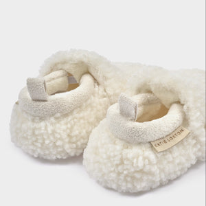 Side view of an off white Borg Baby Shoe with teddy borg finish