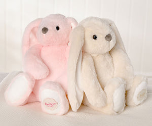 Two bunny rabbit soft toys in pink and cream