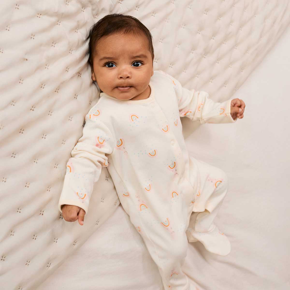 Cream sleepsuit with rainbow and bunny print
