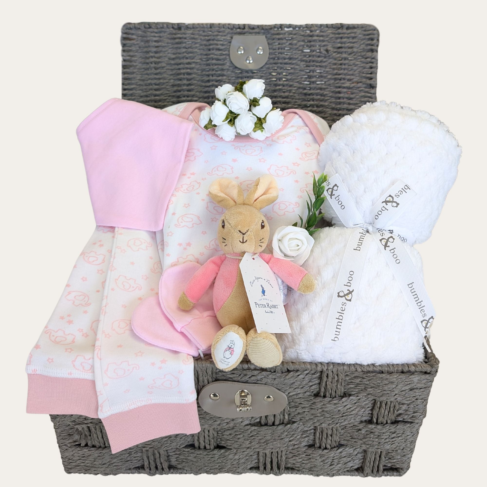 Baby girl hamper basket with gifts of pink pyjamas, white baby blanket, and bunny soft toy. Bumbles and Boo.