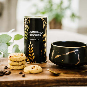 Caramel coffee biscuit snack with latte and gold spoon on rustic board