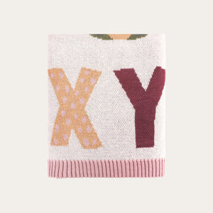 Close-up of knitted alphabet design on organic cotton baby blanket