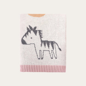 Folded cream alphabet baby blanket made from organic cotton