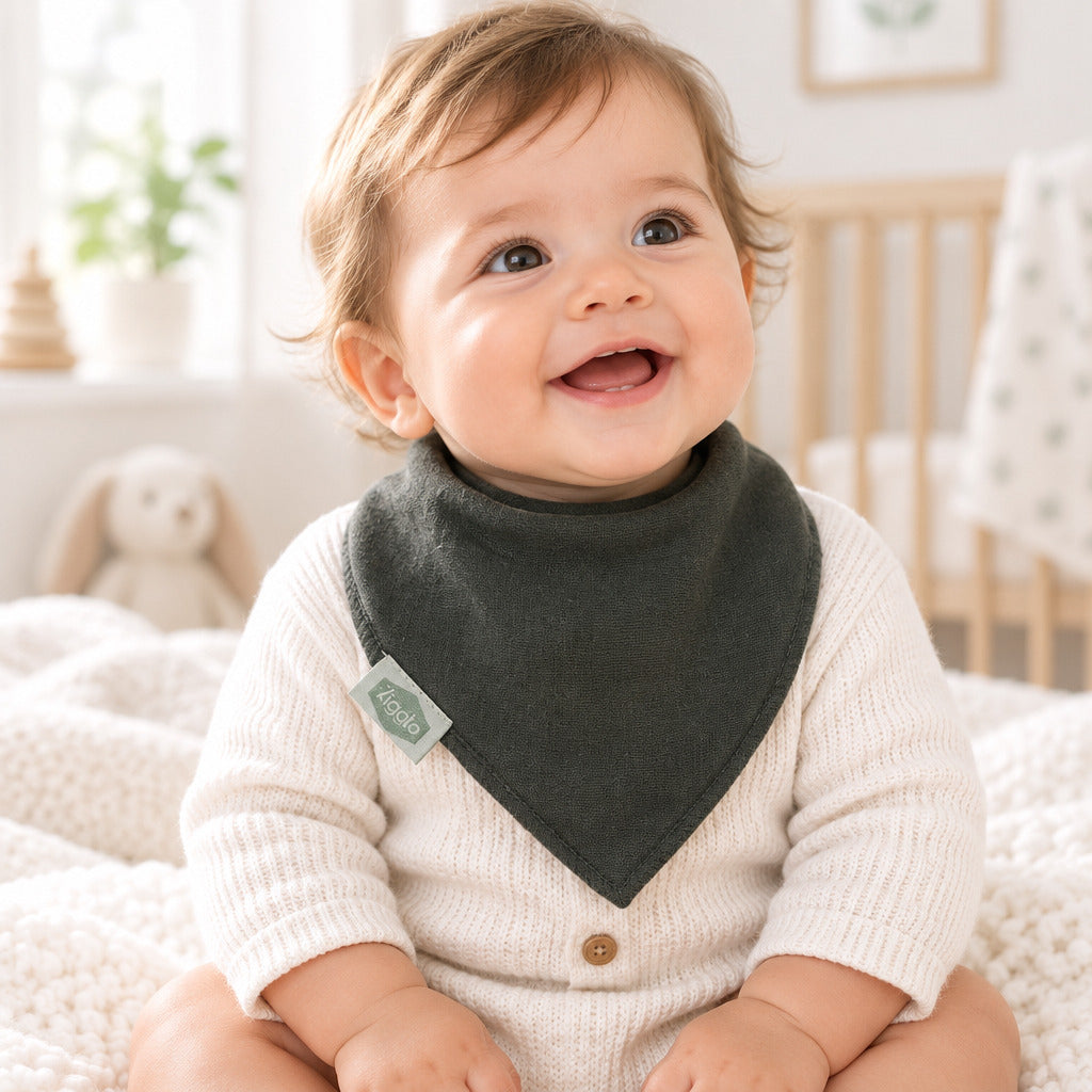 Plain dark green triangular bandana dribble bib with a gathered neckline, stitched edges and a small fabric brand label.