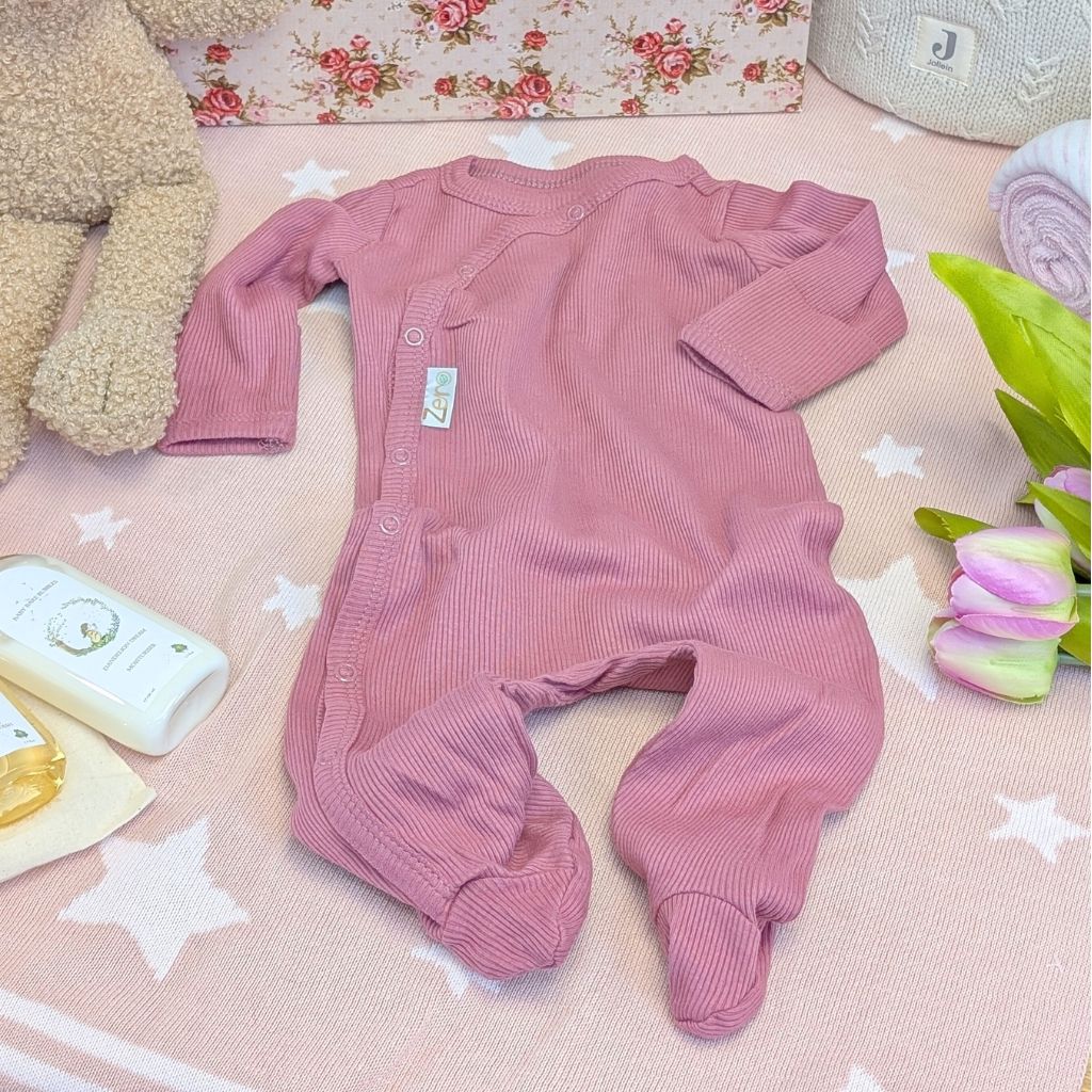 Dusky pink baby girl sleepsuit made from recycled materials and has poppers.