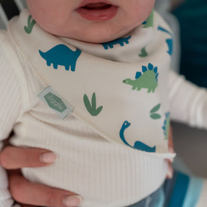 Close-up of dinosaur print dribble bib with cotton fabric and dinosaur pattern
