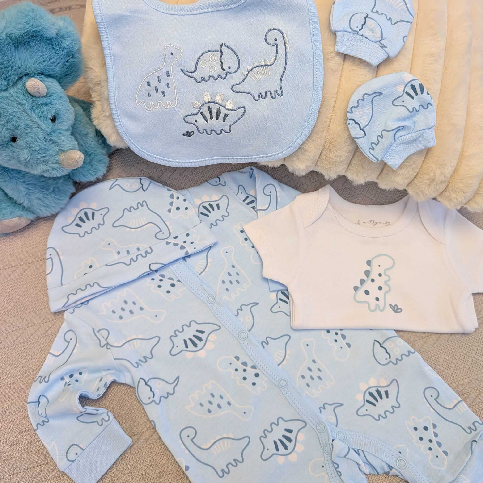 Dinosaur baby clothing gift in blue with hat and mittens and vest.
