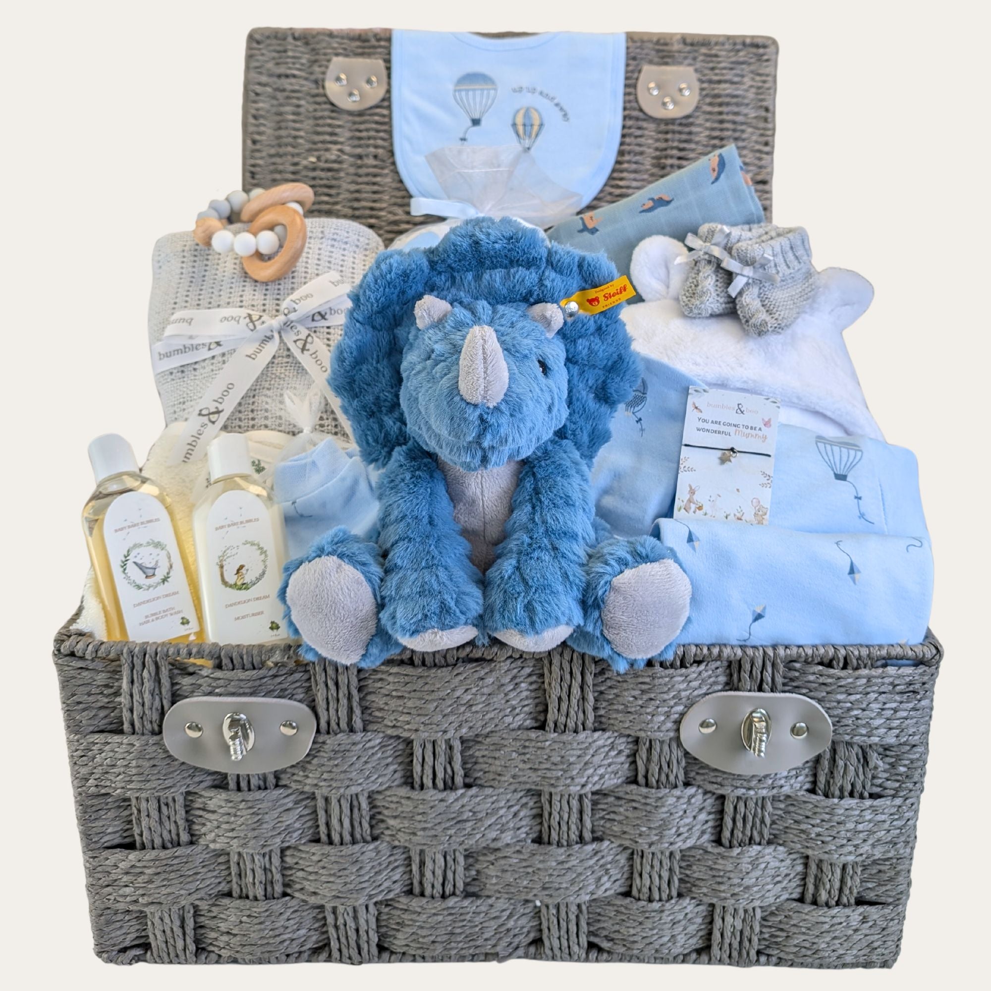 Large baby boy gifts hamper basket with gifts including Steiff dinosaur soft toy and clothing. Bumbles and Boo.